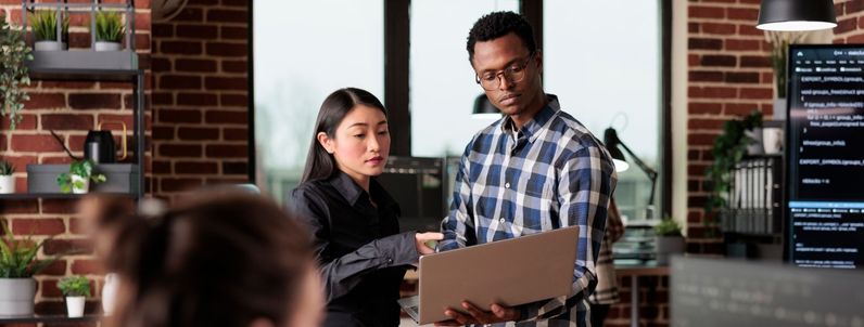 Two people reviewing a laptop